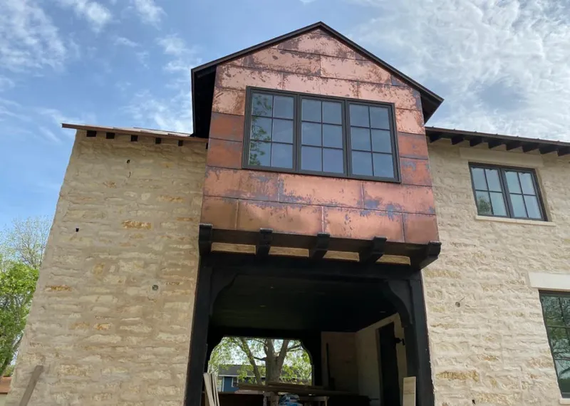 Copper metal panel facade on a stone building for Skylight Installation in Kearns